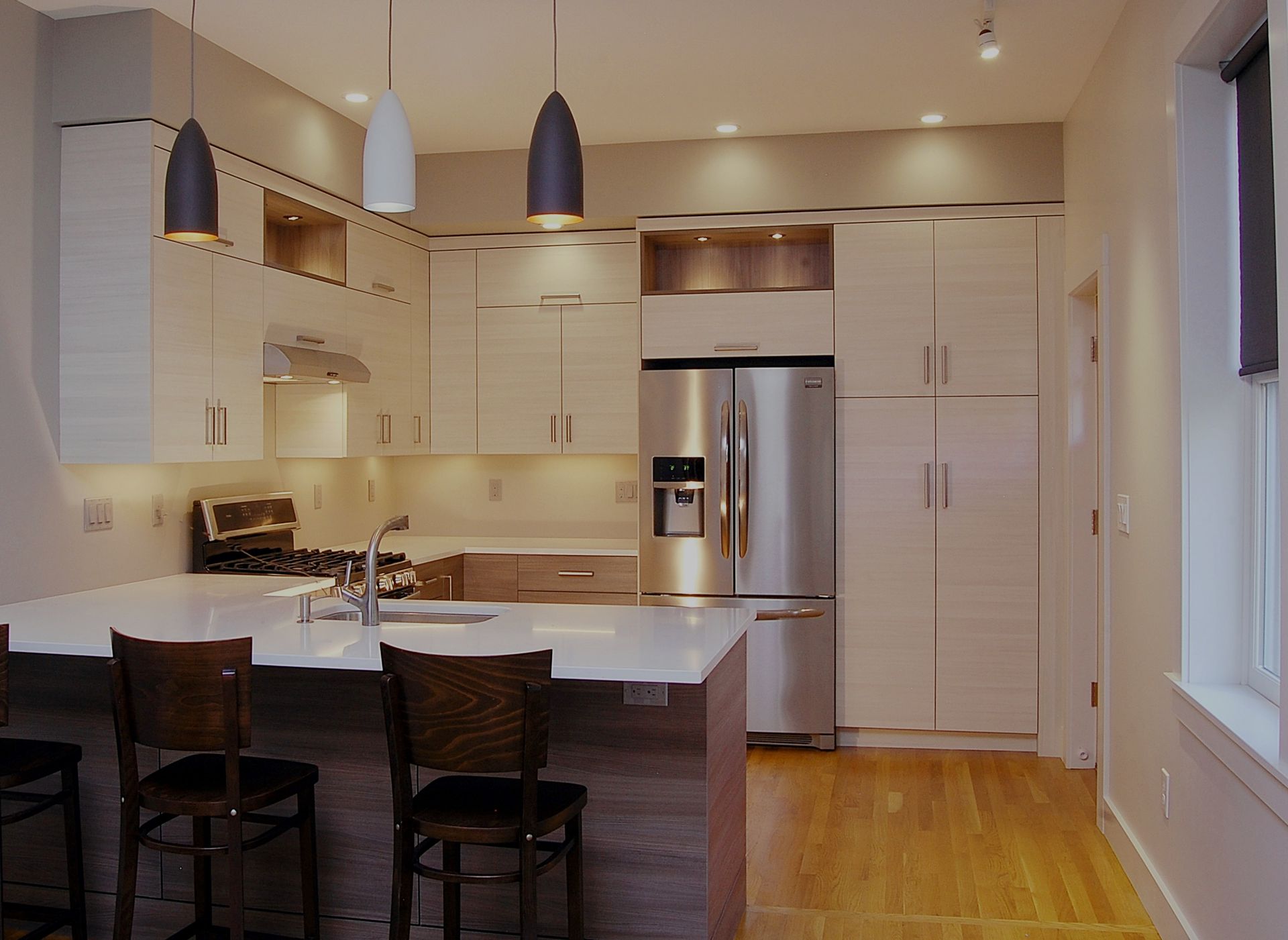 A kitchen with stainless steel appliances and white cabinets