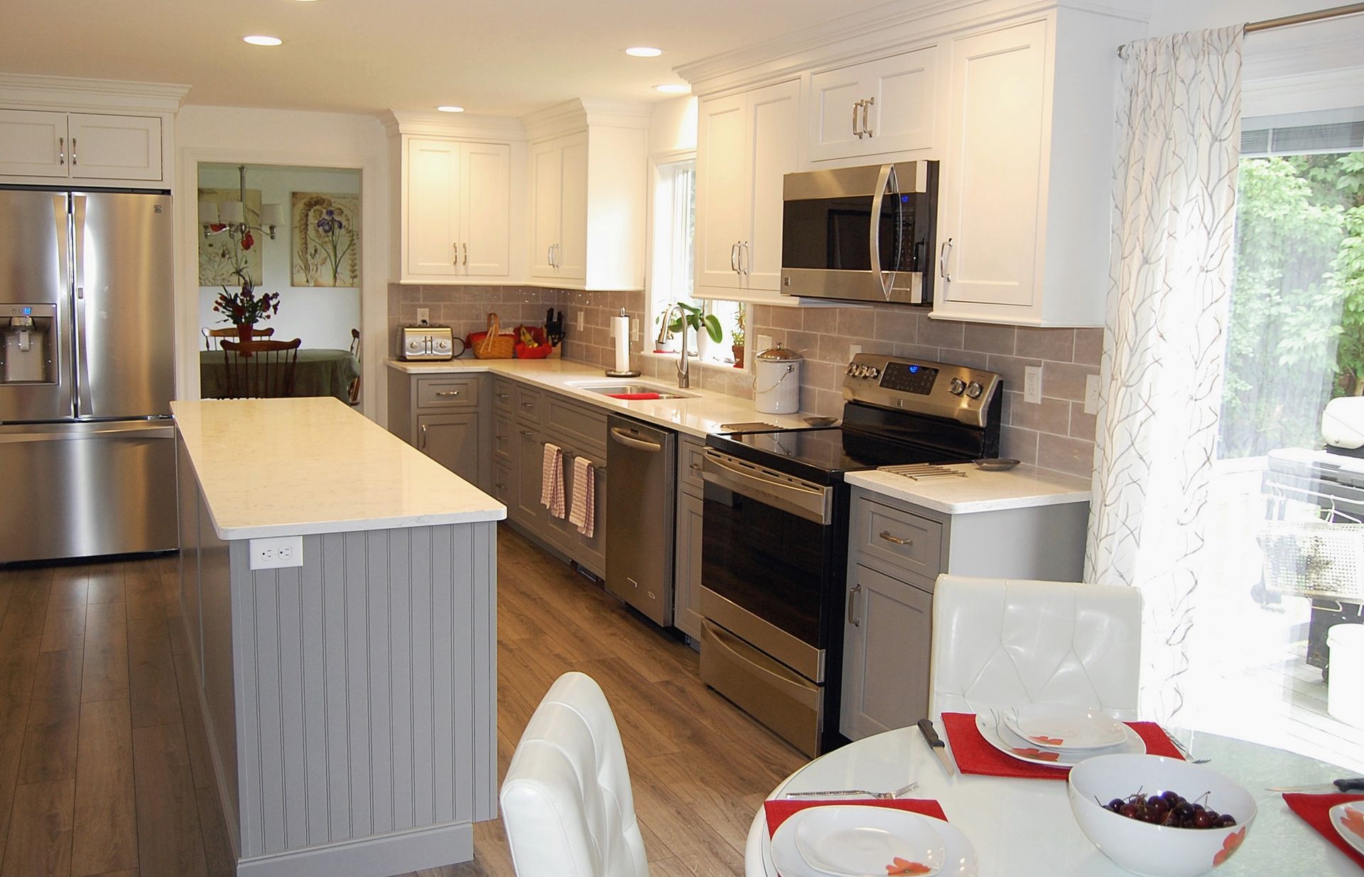 A kitchen with stainless steel appliances and white cabinets