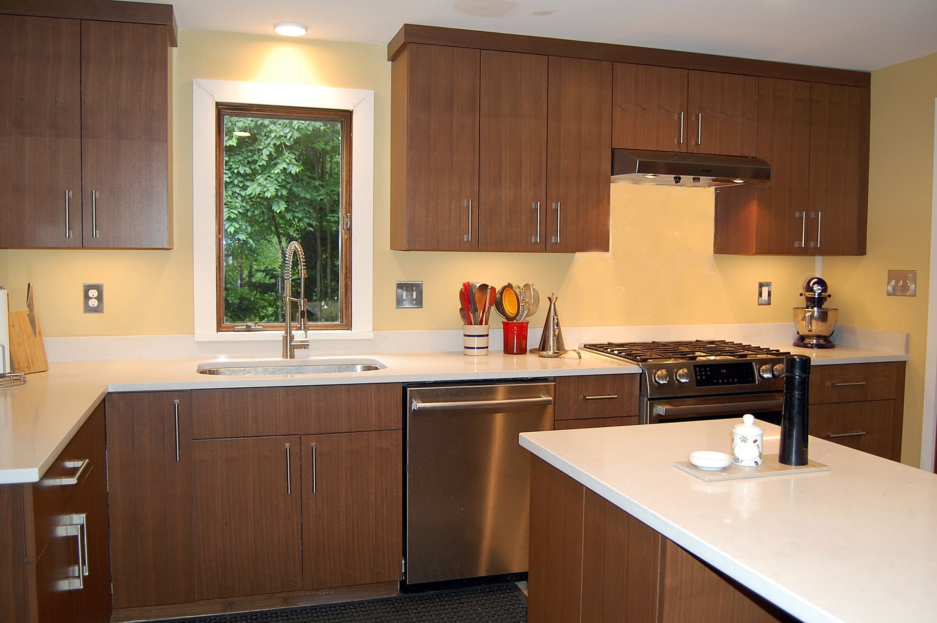 A kitchen with stainless steel appliances and wooden cabinets