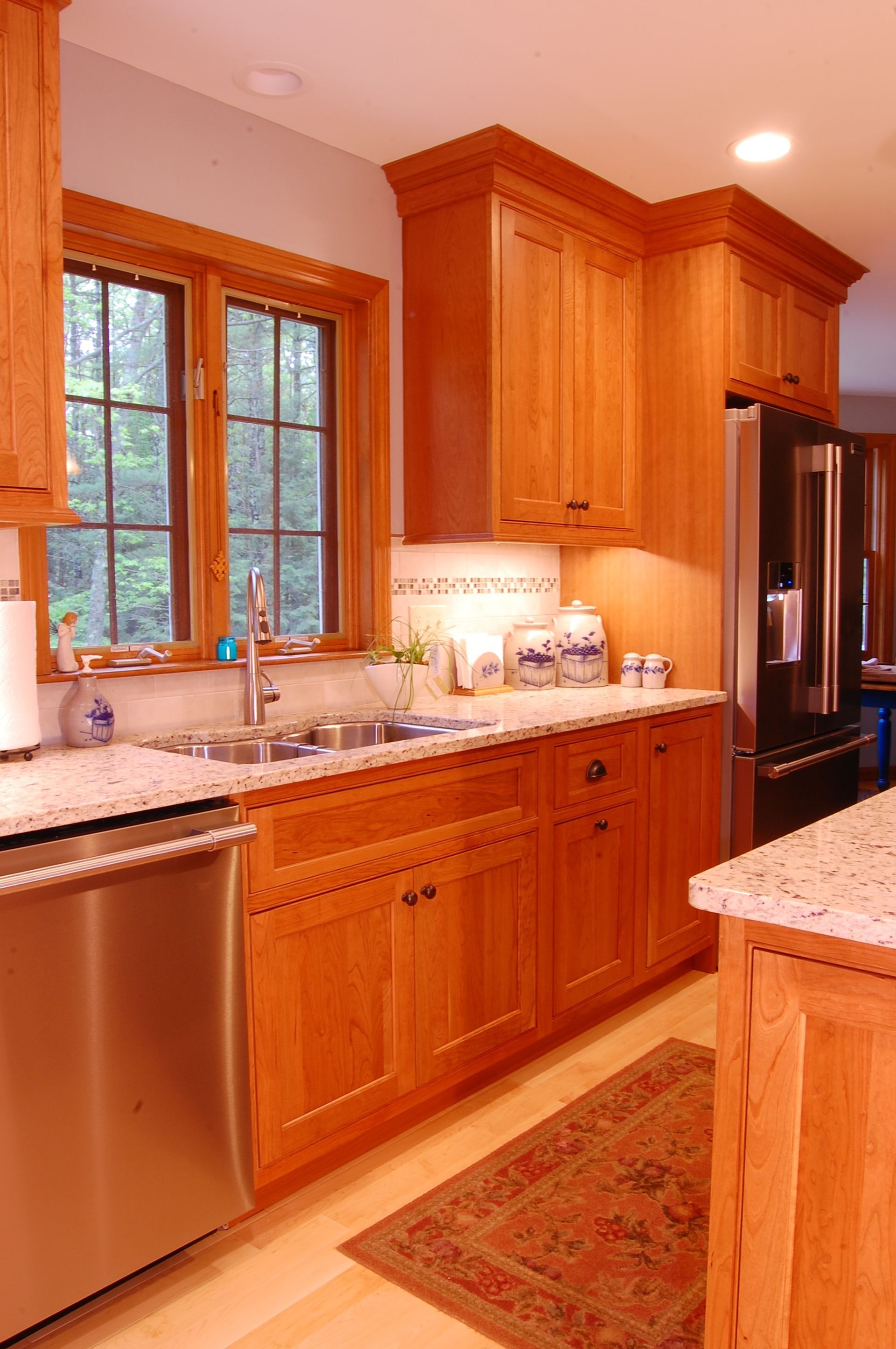 A kitchen with wooden cabinets and stainless steel appliances