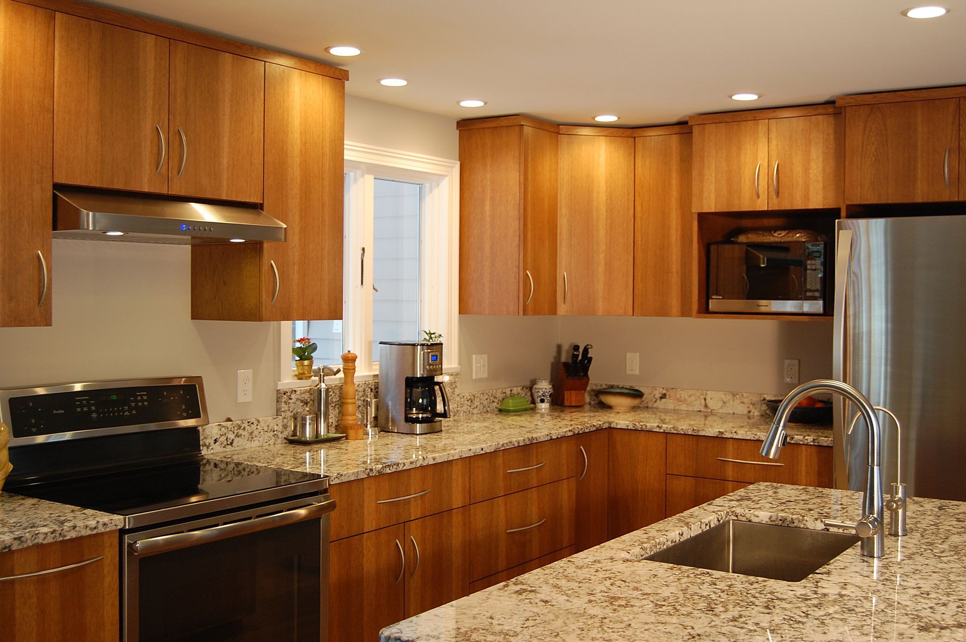 A kitchen with granite counter tops and stainless steel appliances