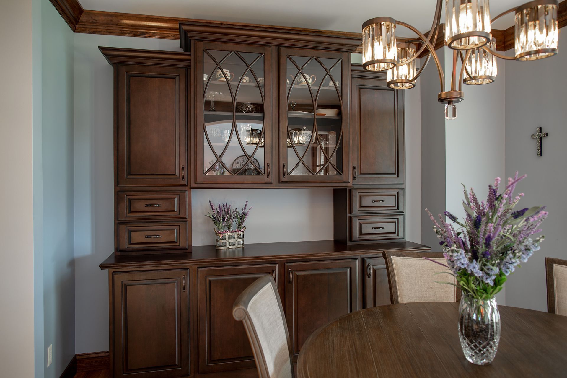There is a vase of flowers on the table in the dining room.