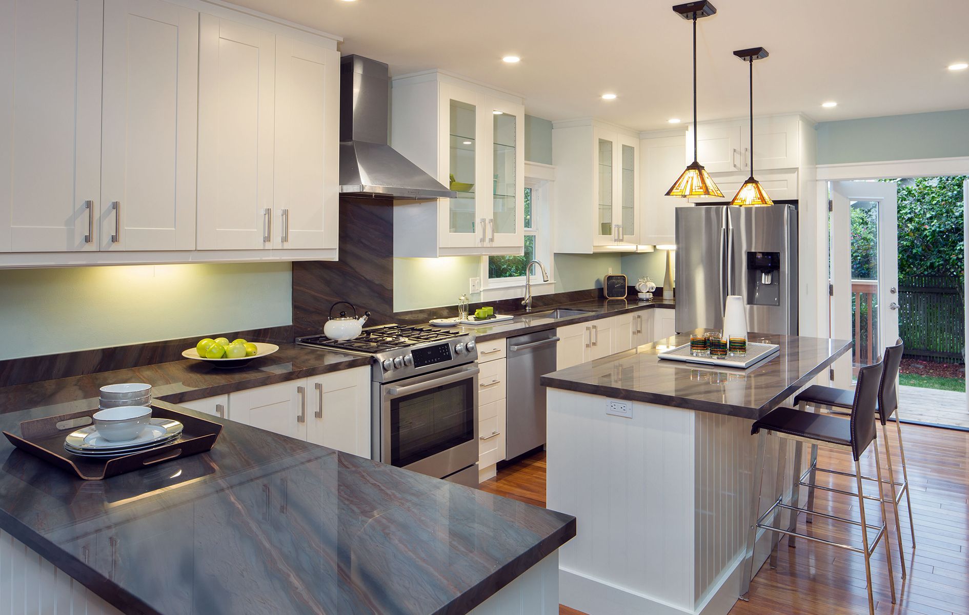 A kitchen with stainless steel appliances and granite counter tops