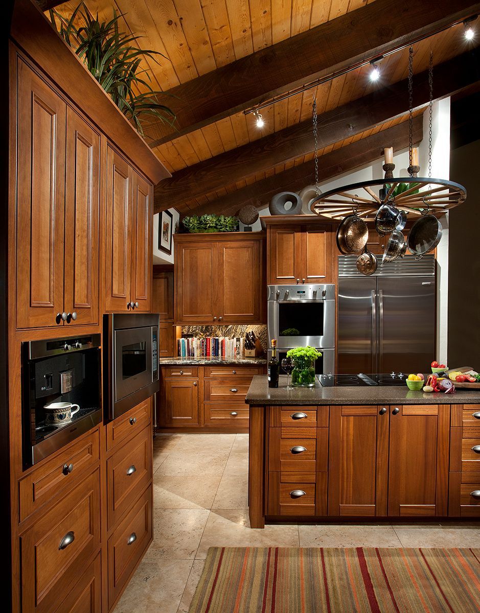 A kitchen with wooden cabinets and stainless steel appliances