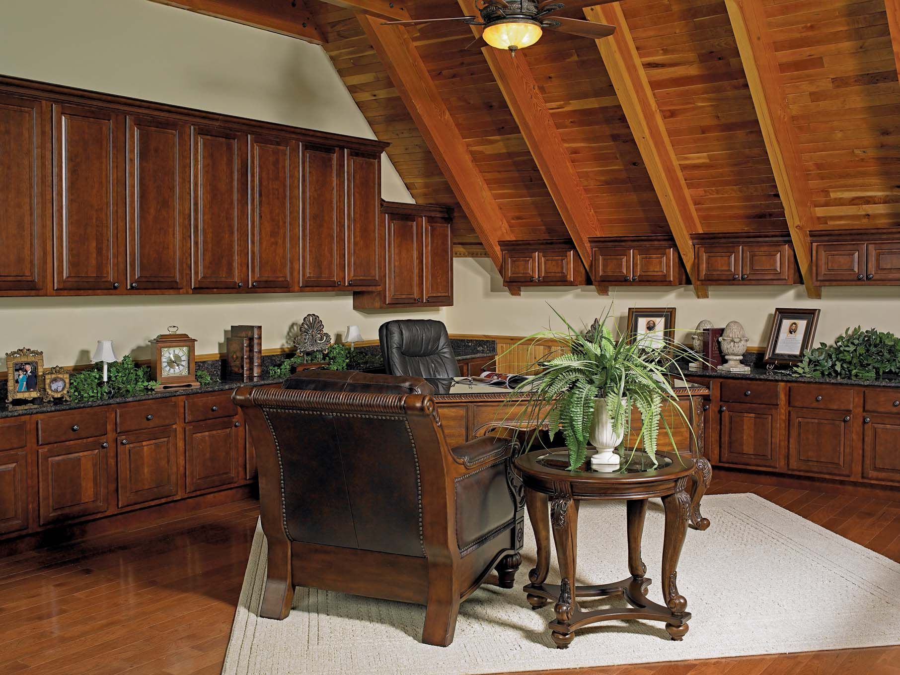 A living room with wooden cabinets and a ceiling fan