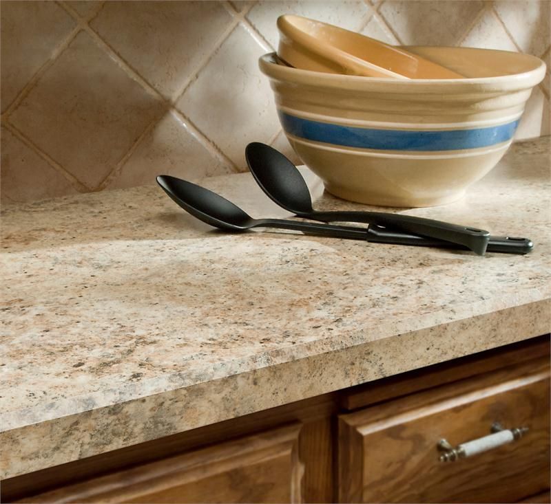 A kitchen counter with a bowl and spoons on it