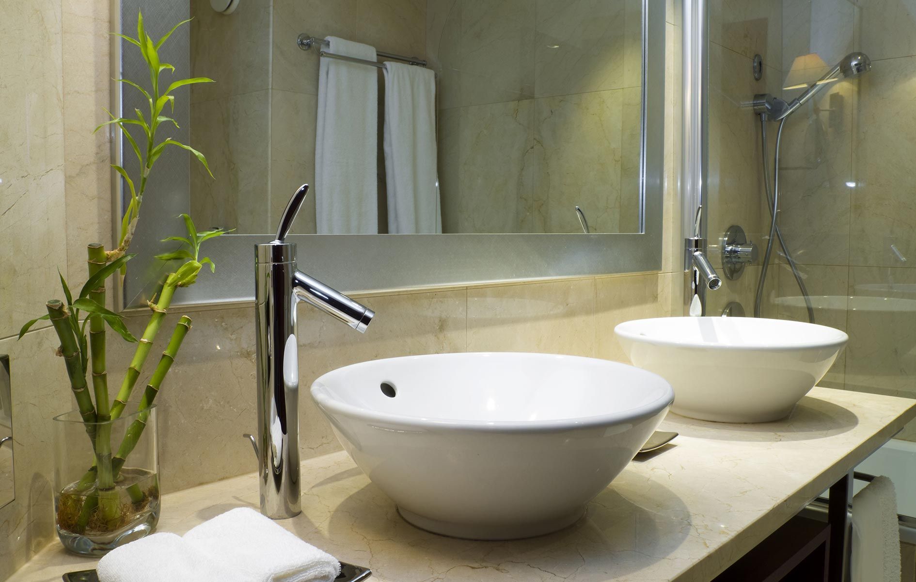 A bathroom with two sinks and a mirror