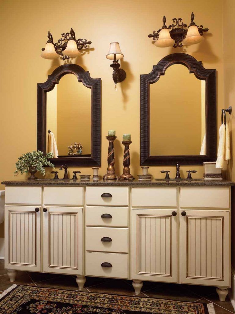 A bathroom with two sinks and two mirrors
