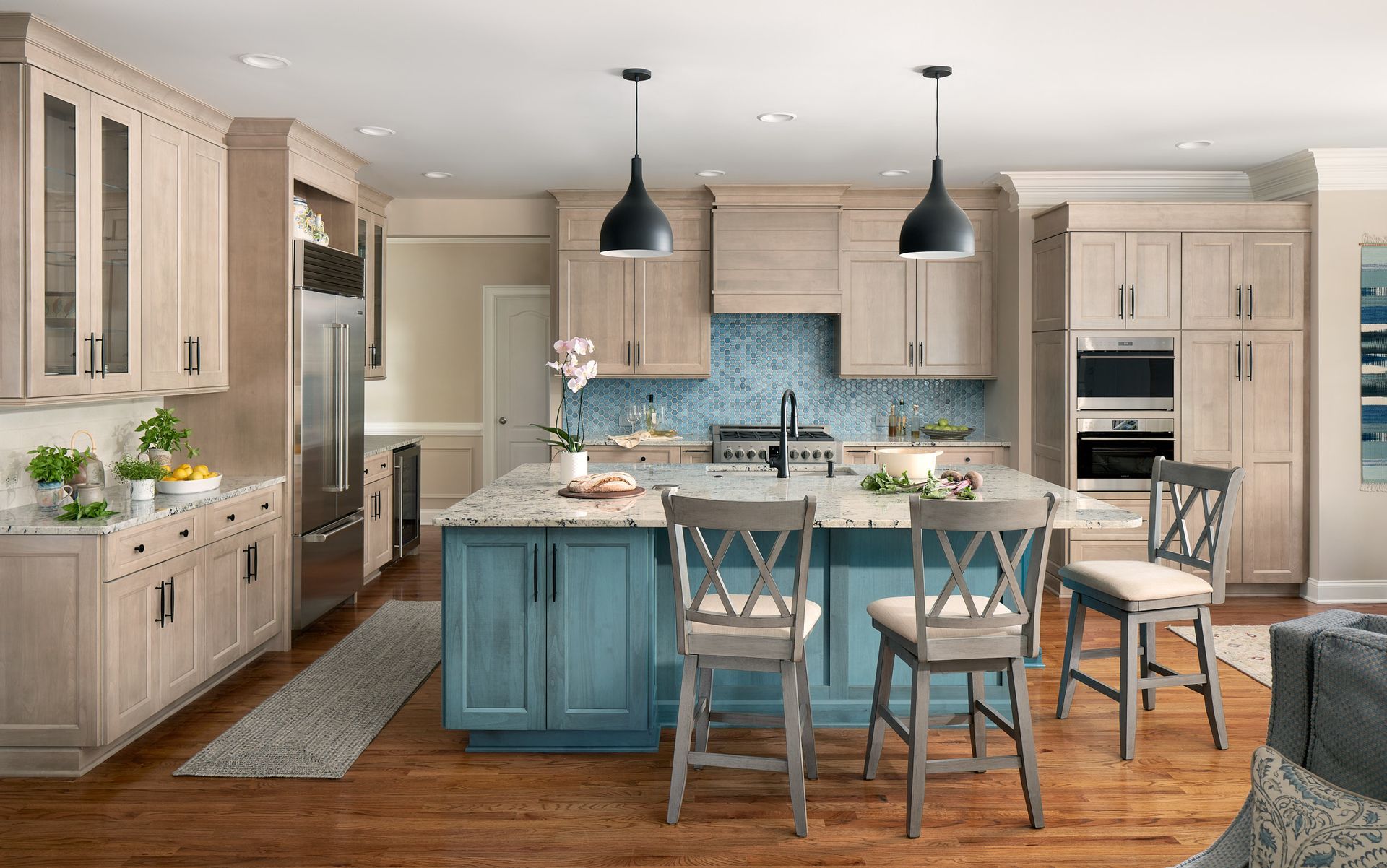 A kitchen with wooden cabinets and a blue island in the middle.