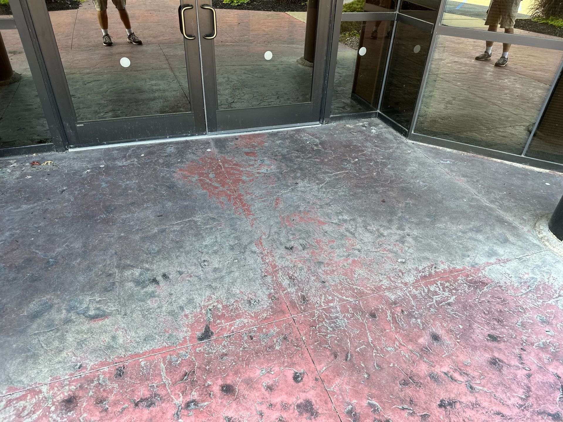 a dirty concrete floor in front of a building