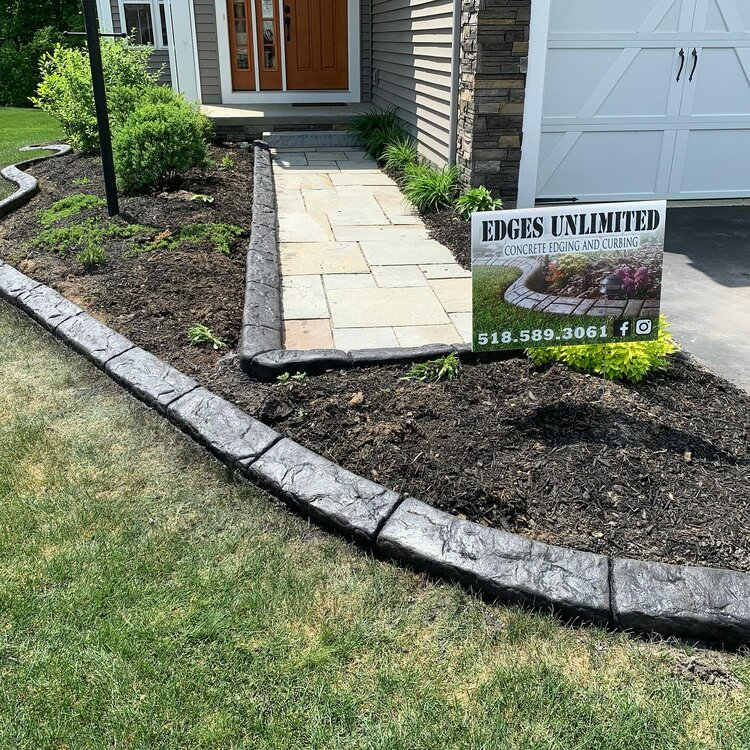 there is a sign in front of a house that says `` edges unlimited '' .