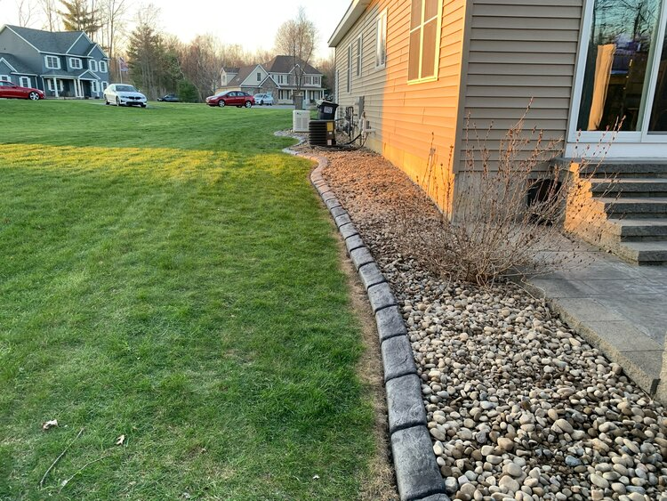 there is a house in the background and a lawn in the foreground .