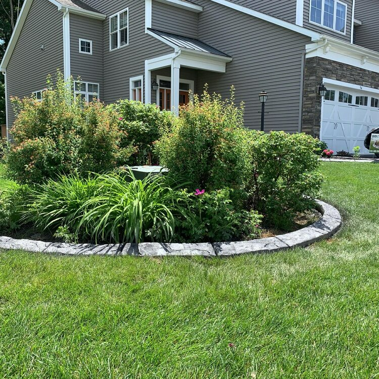 a large house with a lush green lawn in front of it .