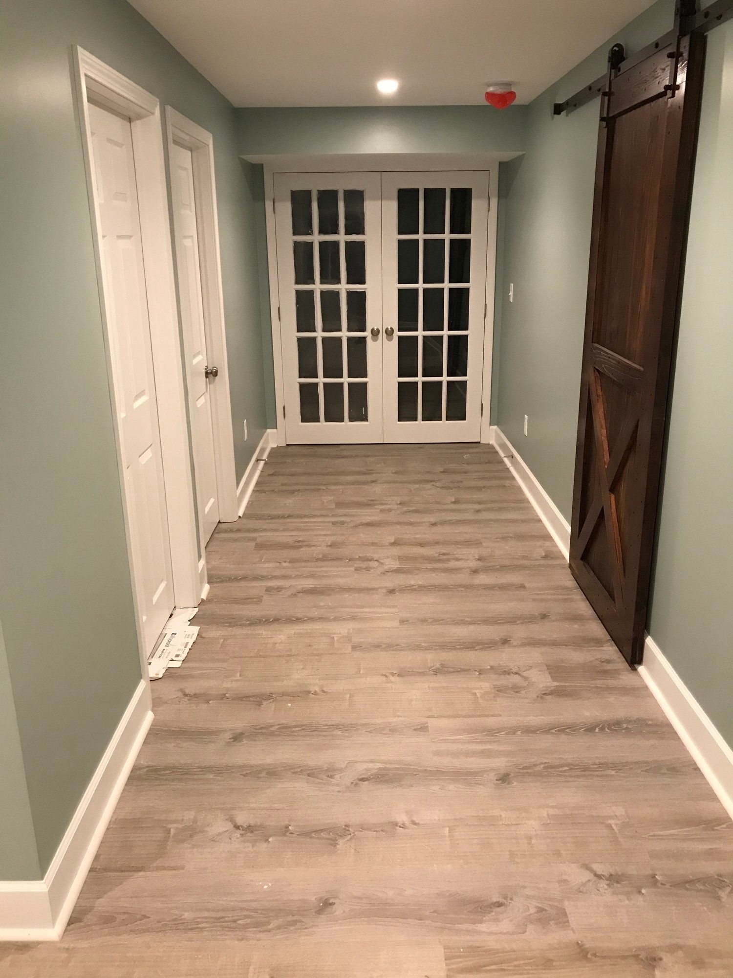 a hallway with hardwood floors and sliding glass doors