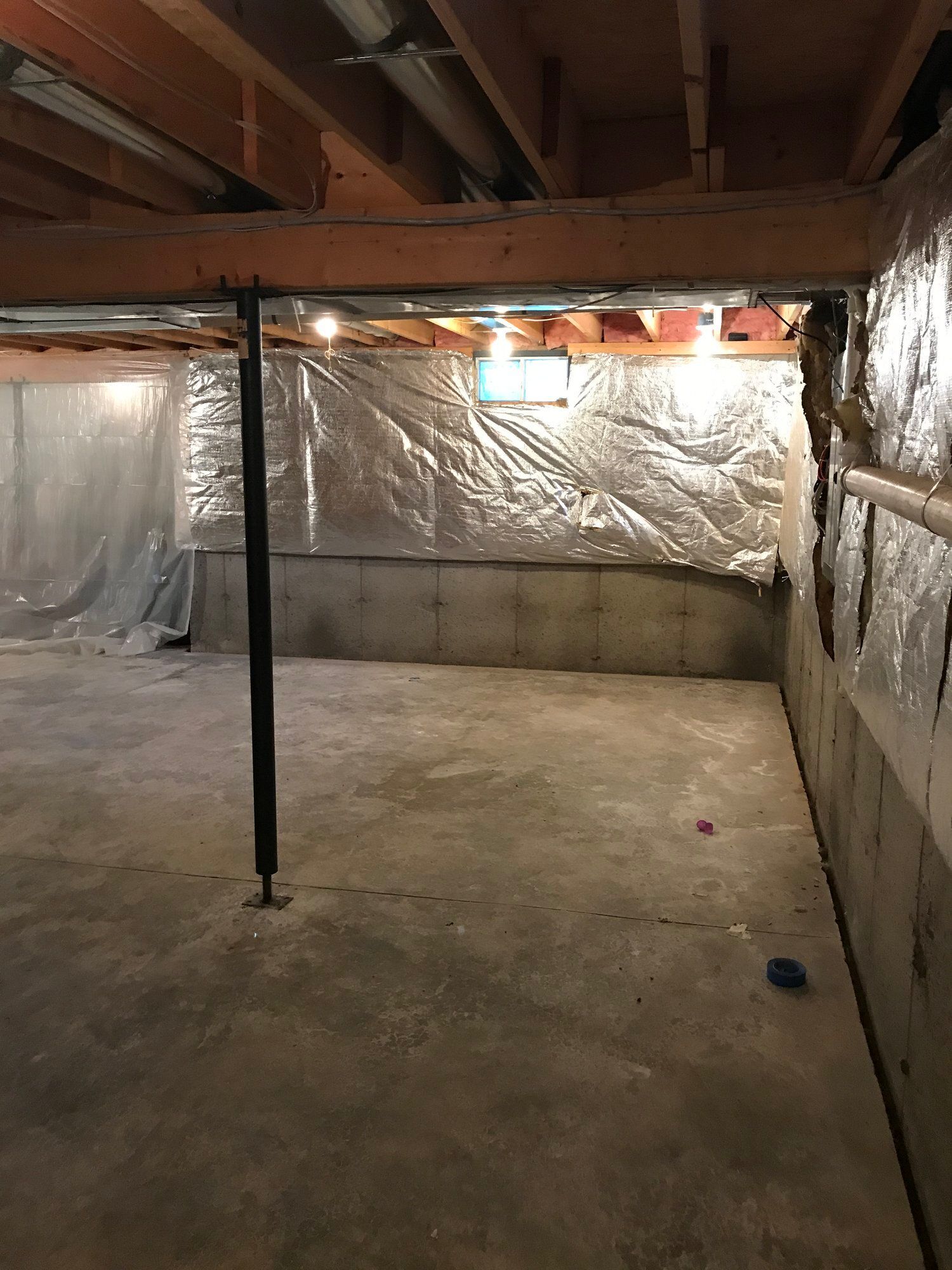 an empty basement with aluminum foil on the walls and ceiling