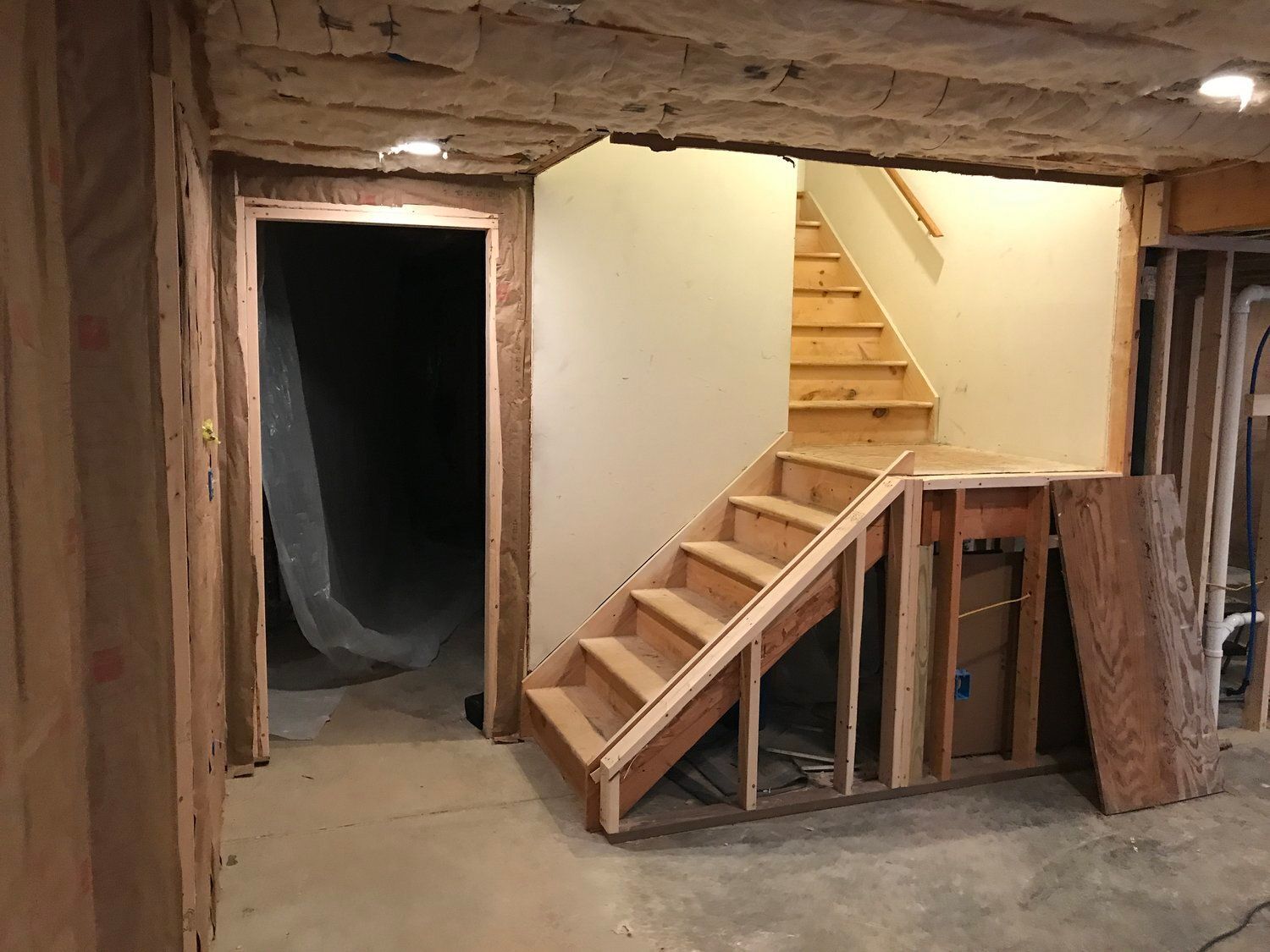 a wooden staircase is being built in a basement