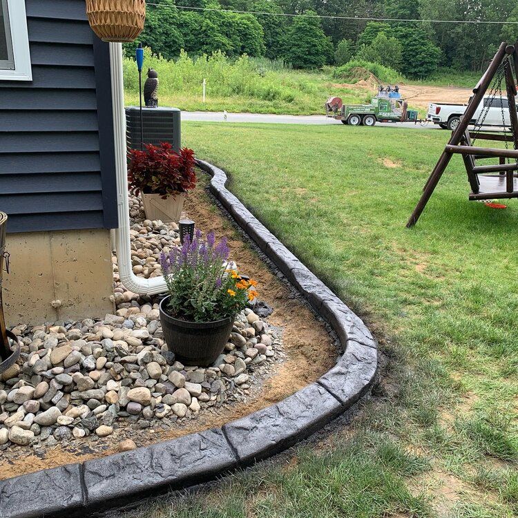 a concrete curb is being installed in front of a house