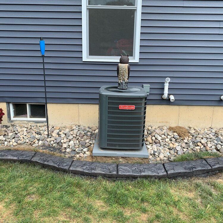 an air conditioner is sitting on the side of a house