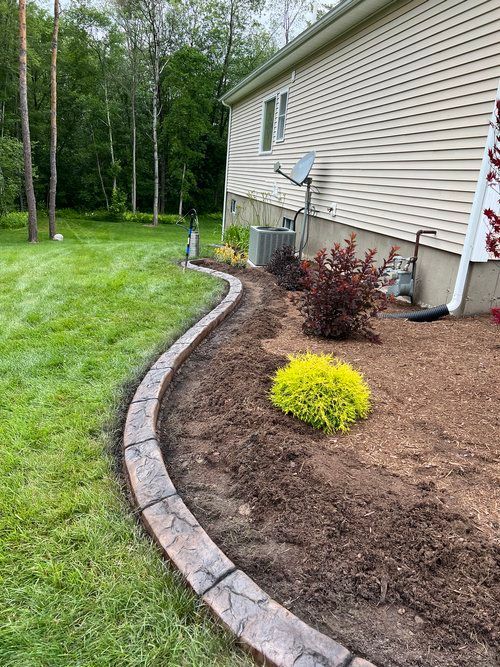 a house with a concrete curb in front of it