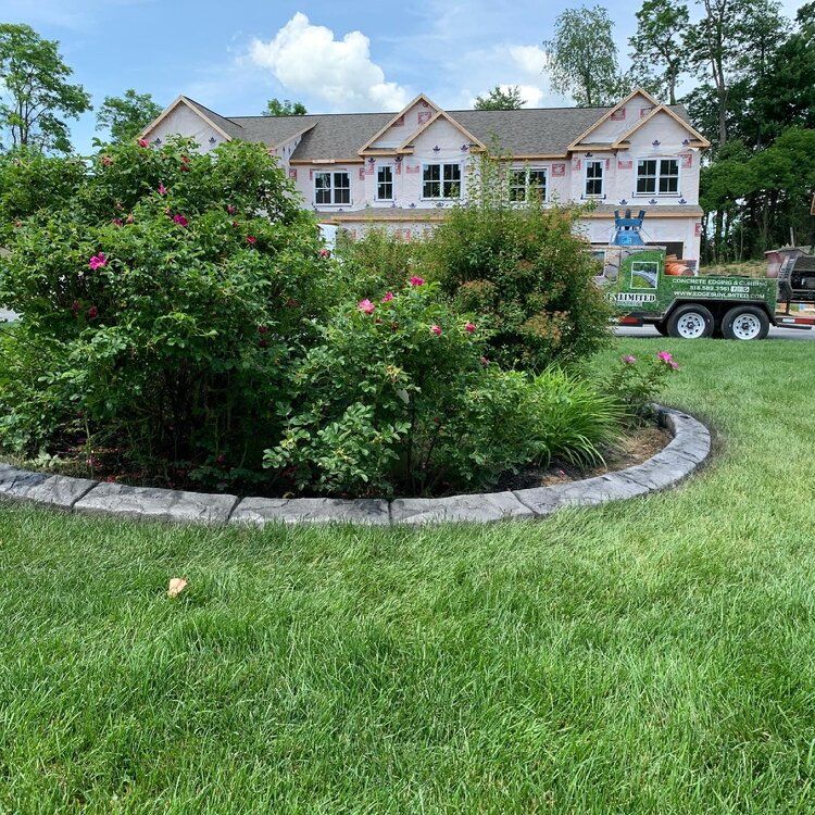 a green truck is parked in front of a house under construction