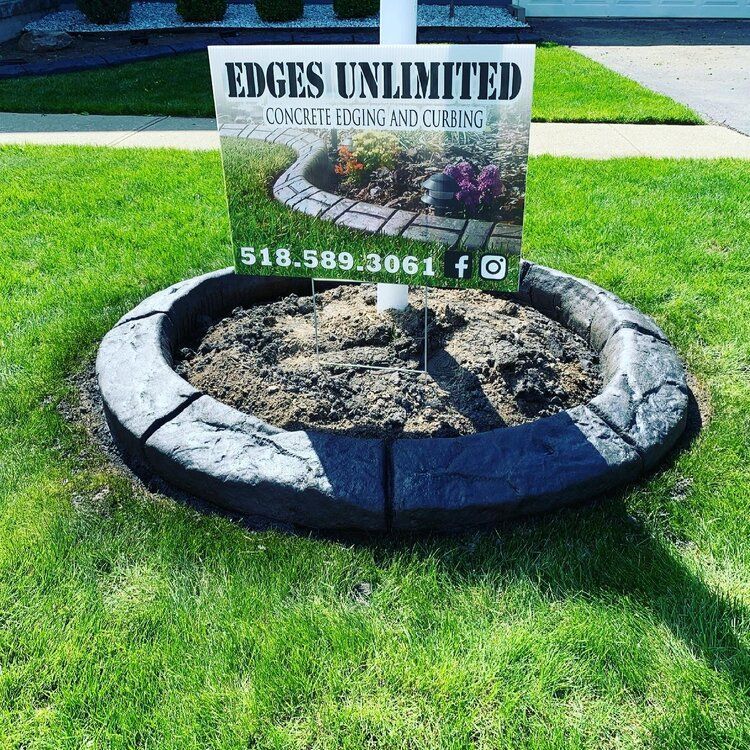a sign for edges unlimited concrete edging and curbs