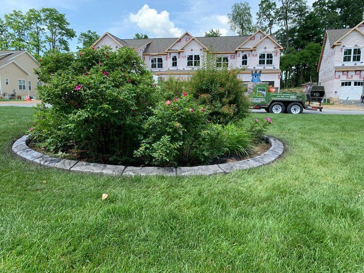 a lawn mower is cutting the grass in front of a house
