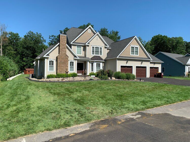 a large house with a lot of grass in front of it
