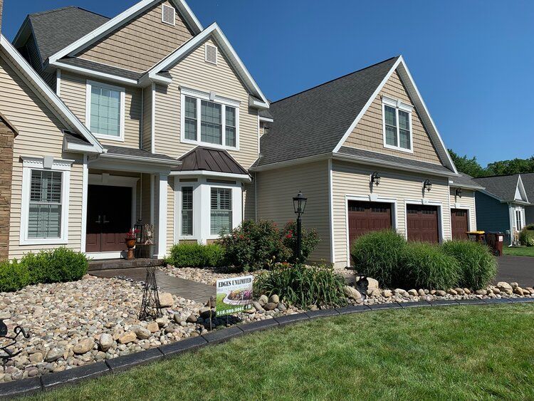 a large house with a sign in front of it