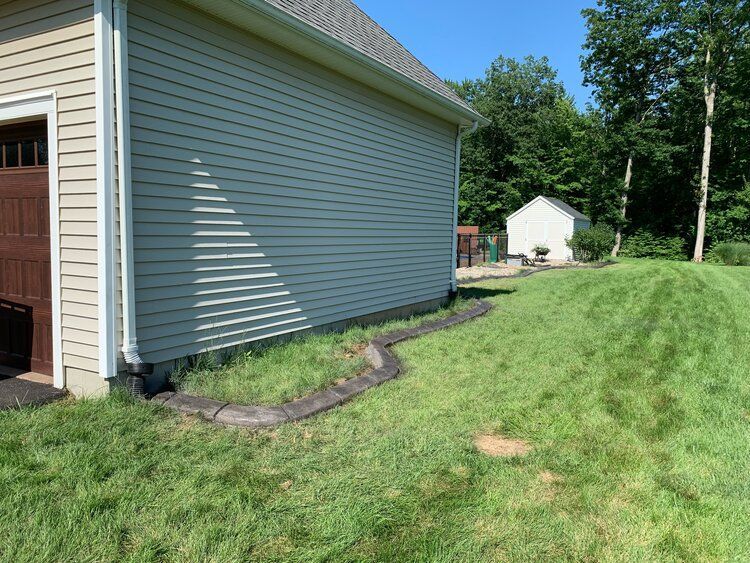 a house with a garage and a sidewalk in front of it