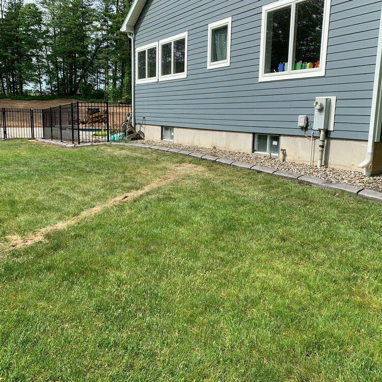 a large house with a lush green lawn in front of it