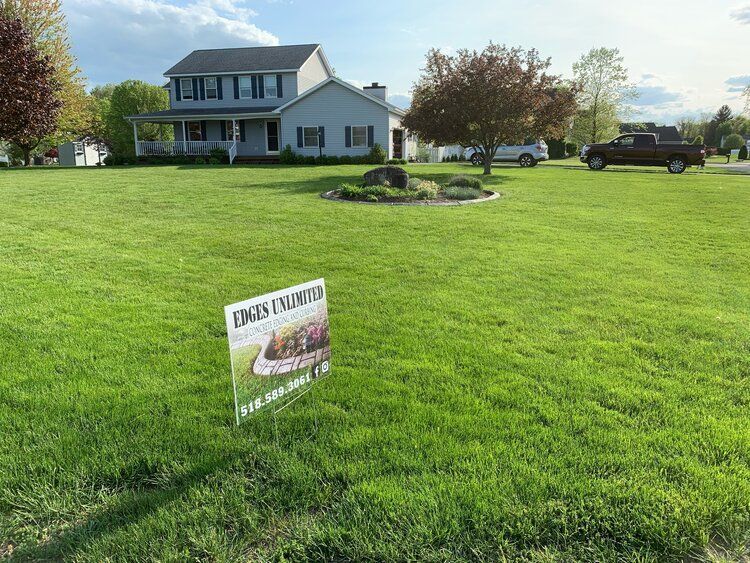 a house with a lot of grass and a sign in front of it