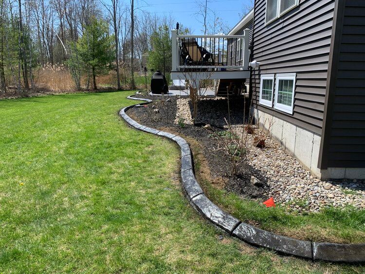 there is a concrete curb in the backyard of a house