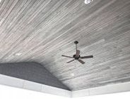 Gray wooden ceiling with a ceiling fan.