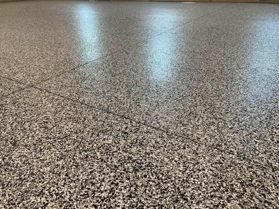Gray speckled epoxy floor reflecting light.