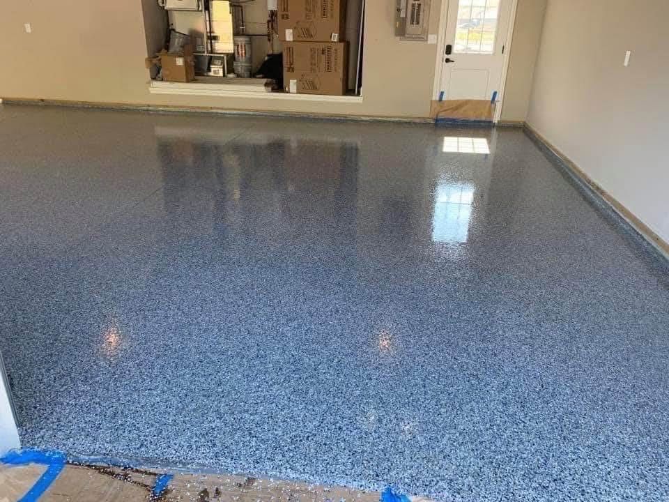 Garage with blue speckled epoxy floor reflecting natural light.