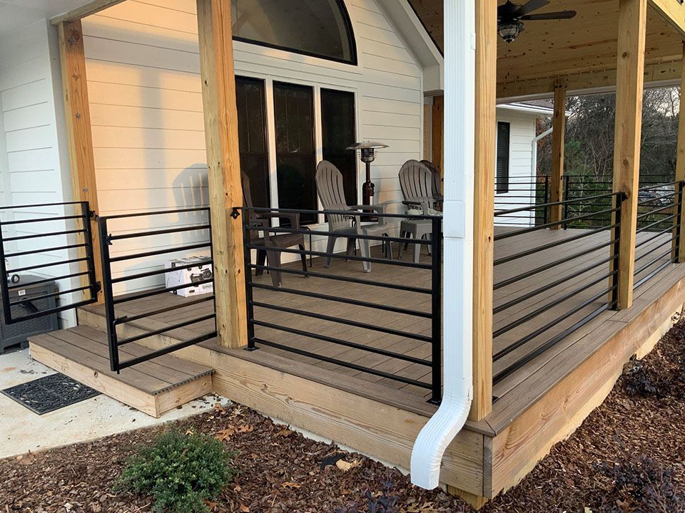A white truck is parked on the side of the road next to a railing.