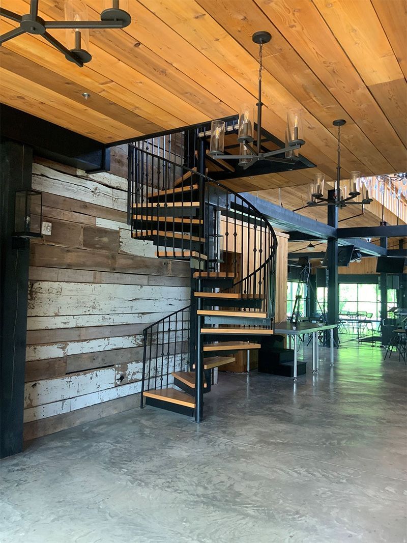 There is a spiral staircase in the middle of the room.