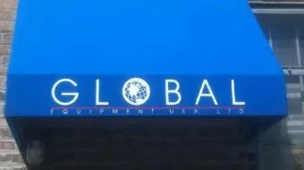 Blue awning sign reading “GLOBAL” above a storefront entrance