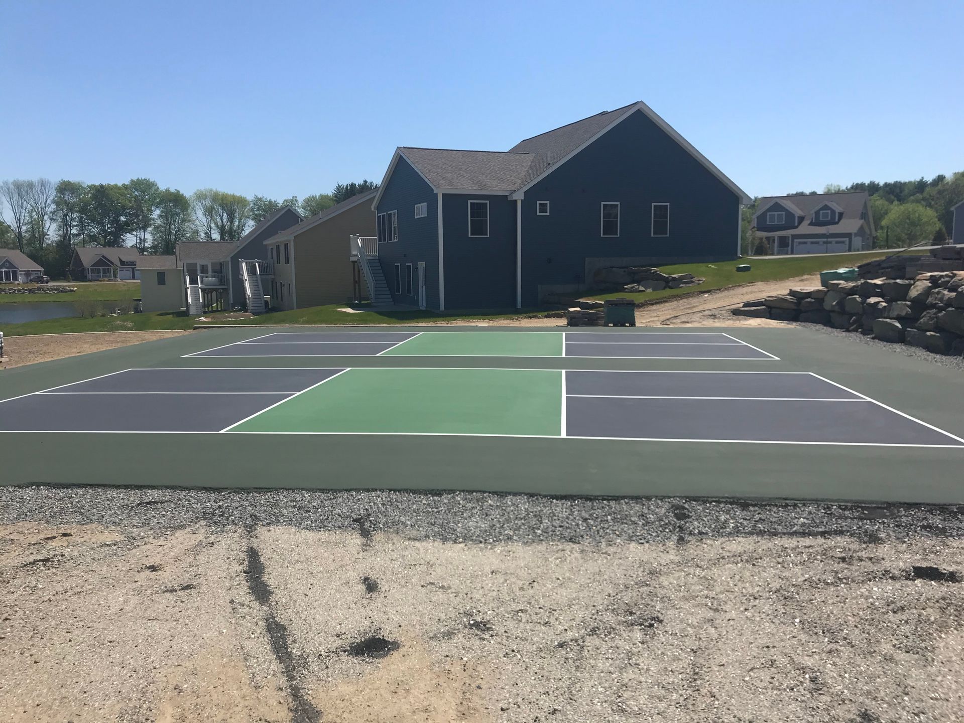 a tennis court is being built in front of a house
