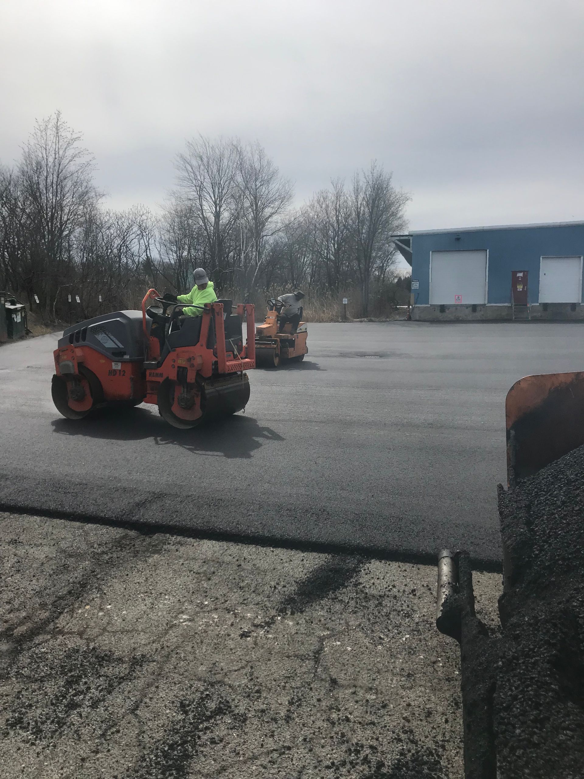 a group of construction workers are working on a road