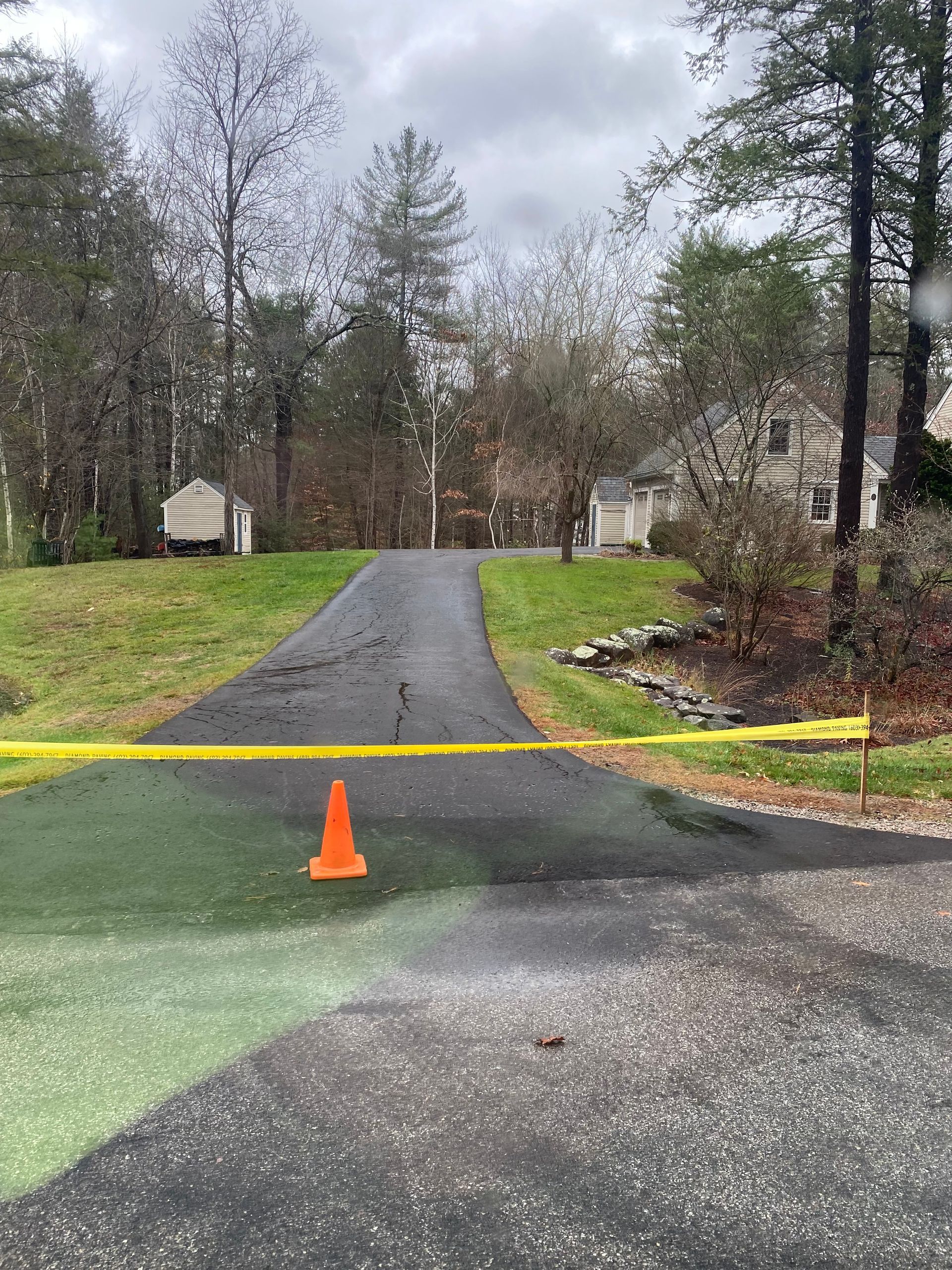an orange cone is sitting on the side of a road