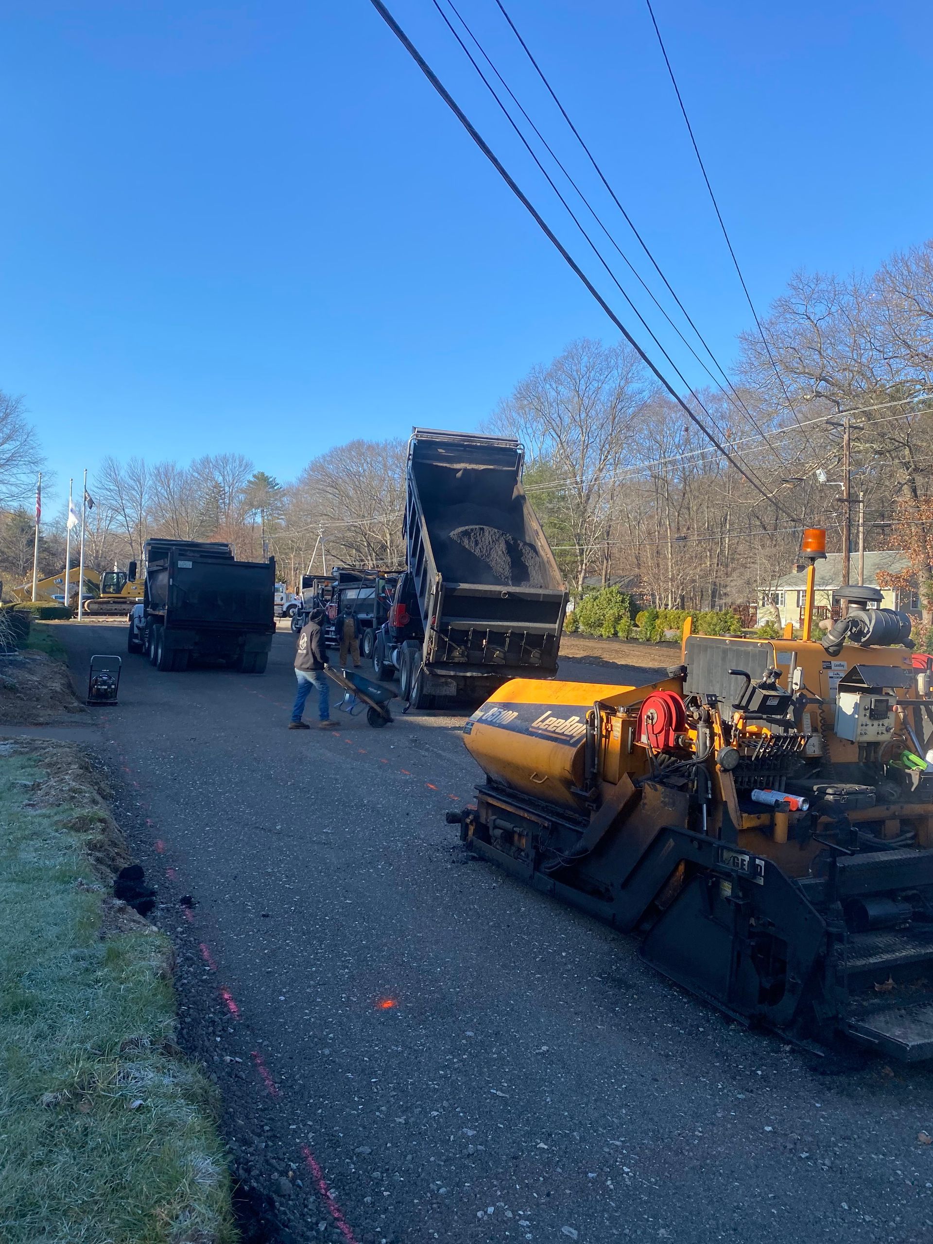 a group of construction workers are working on a road