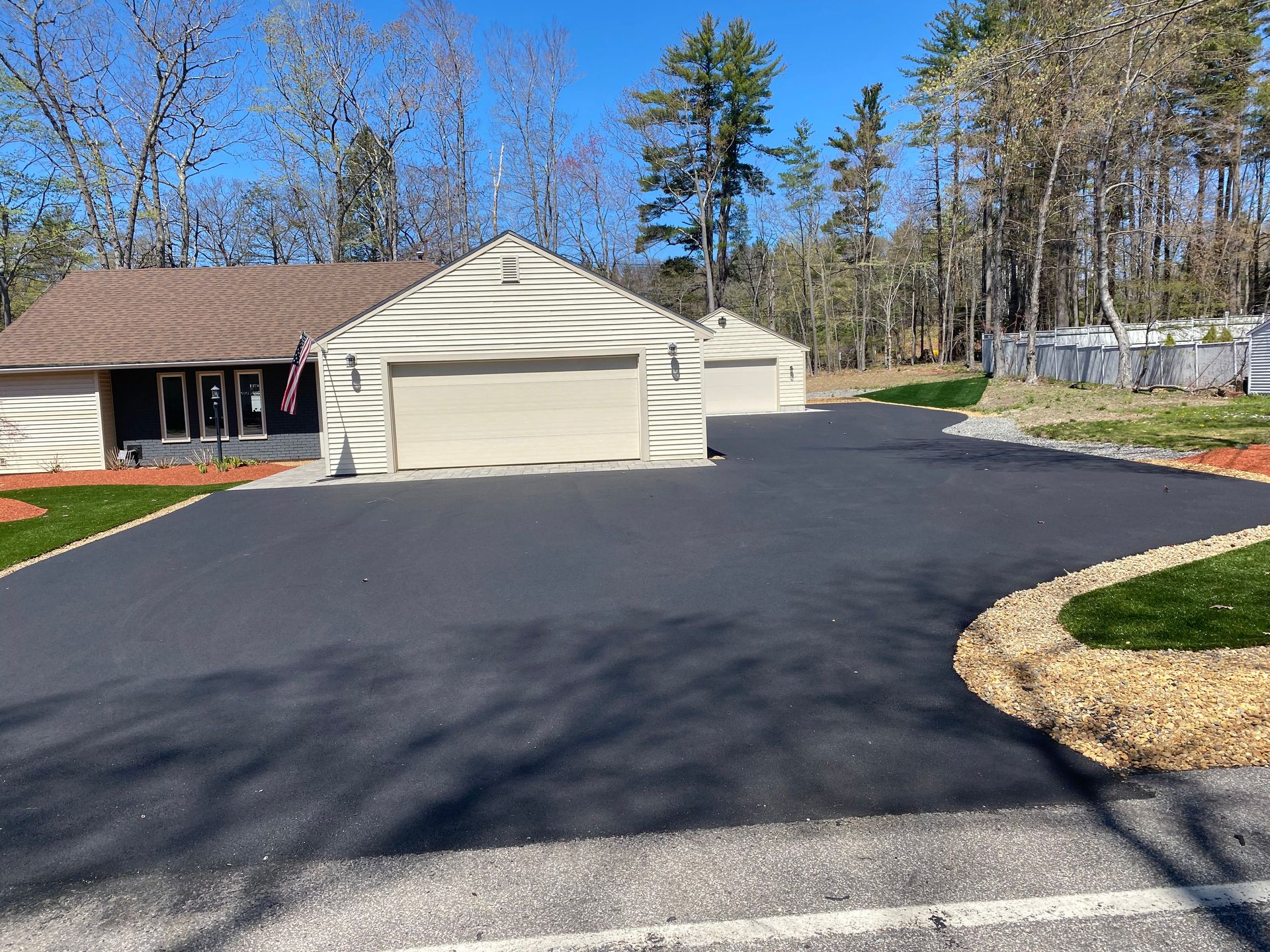 a driveway leading to a house with two garages