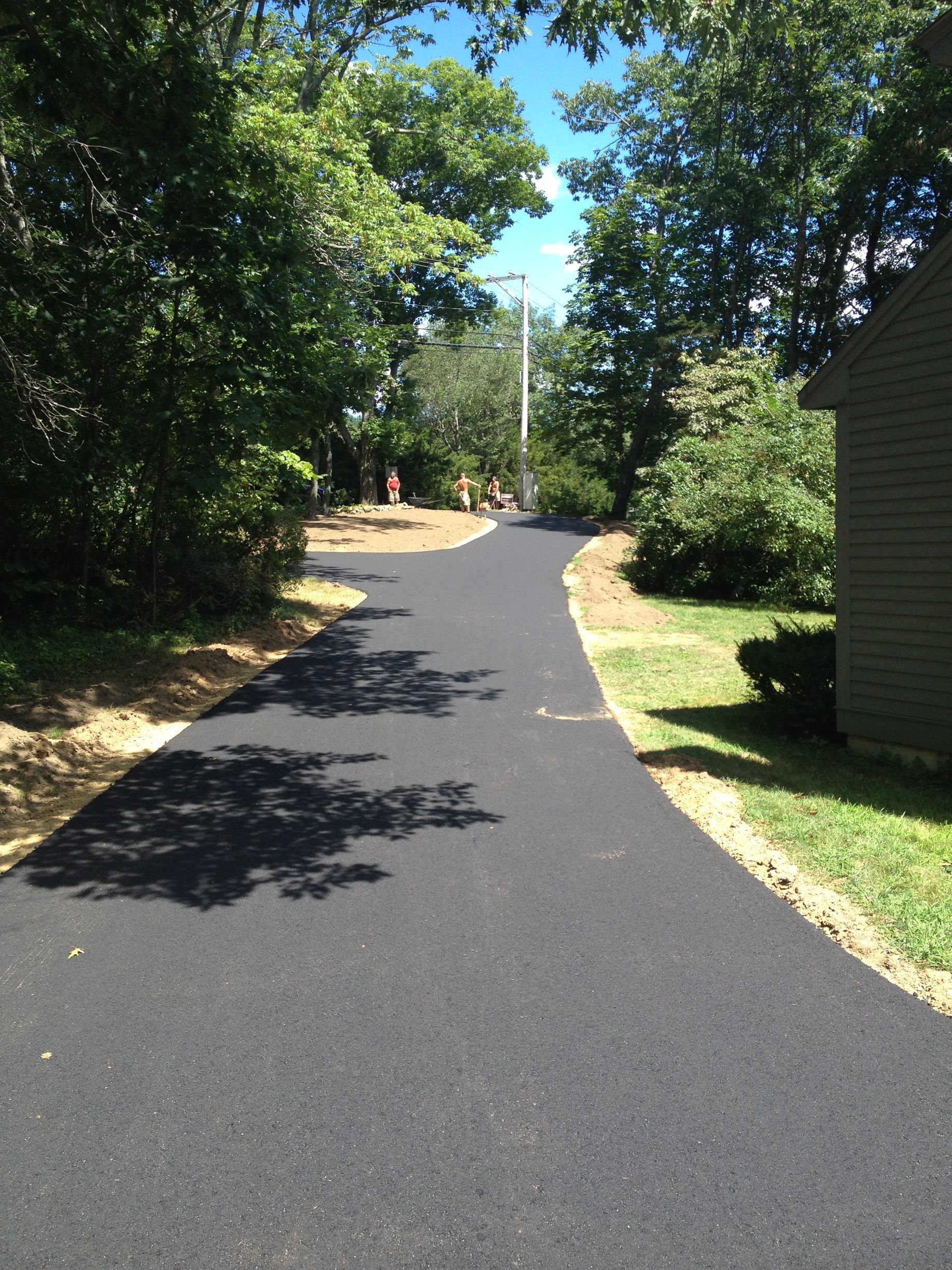 a road that is surrounded by trees and grass