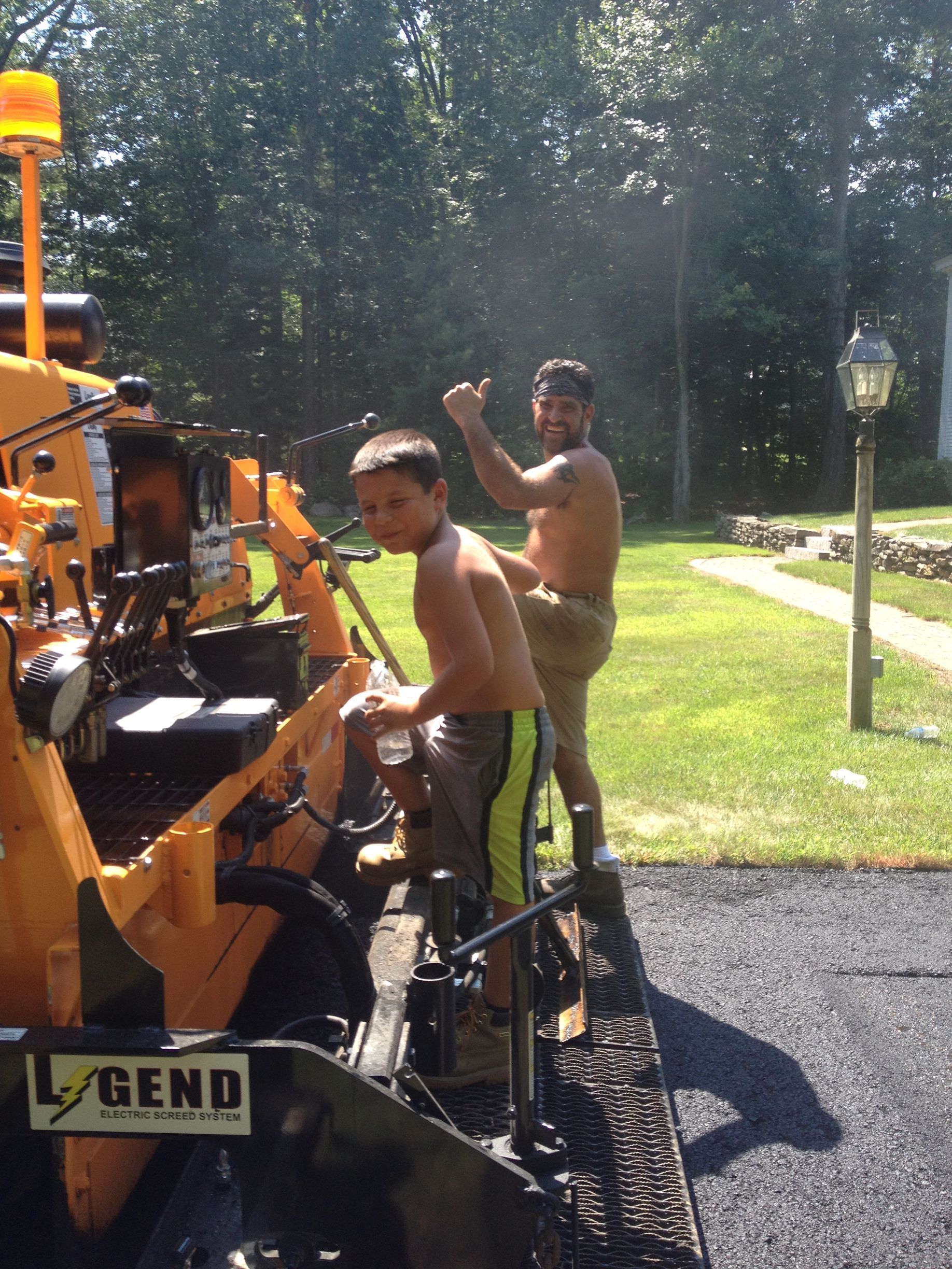 two men are working on a machine that says legend on it