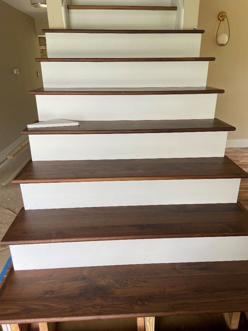 A staircase with wooden steps and white risers in a house.
