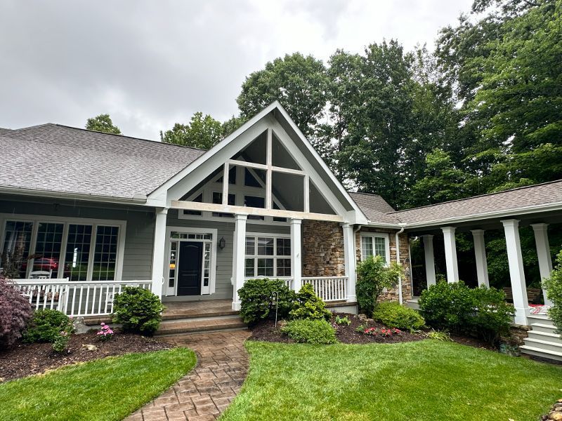 A large house with a porch and a walkway leading to it.