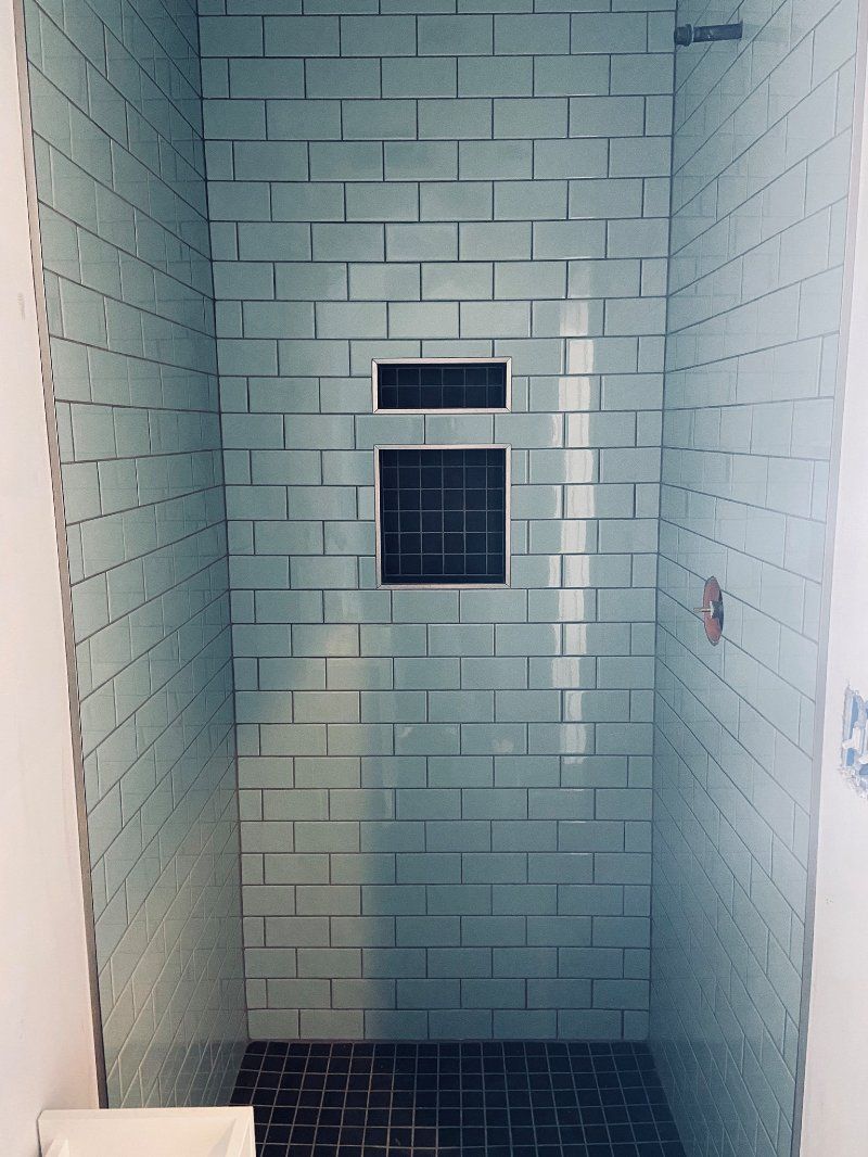 A bathroom with a brick wall and a toilet.