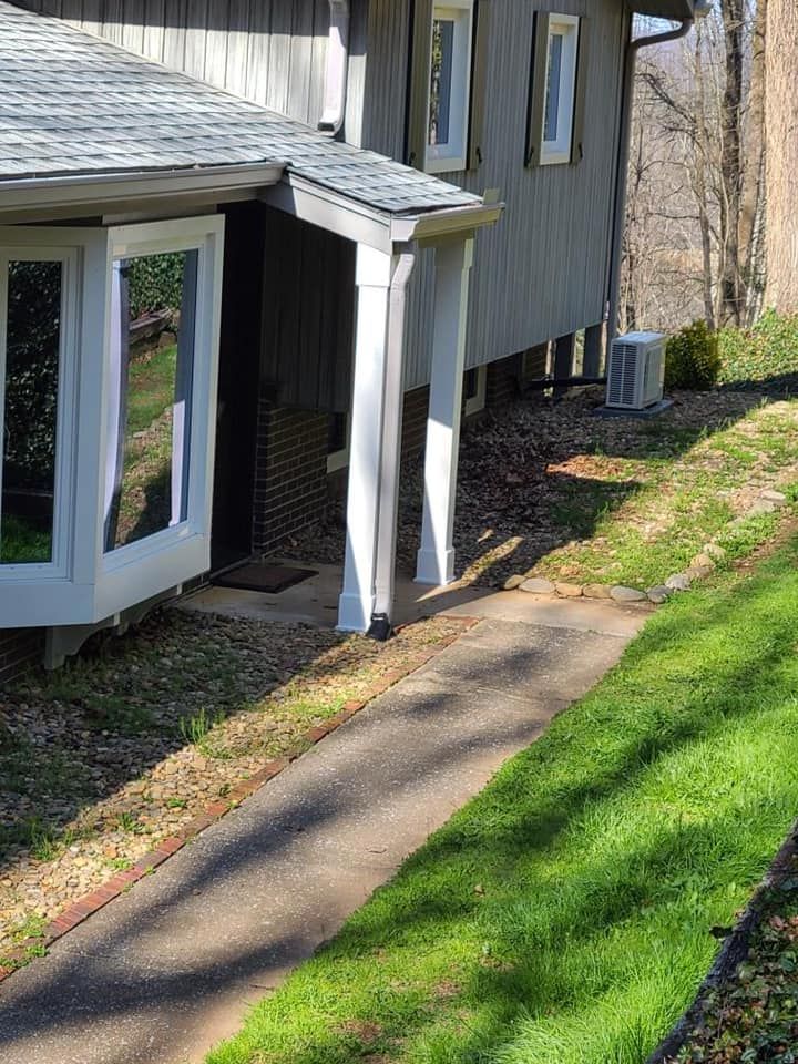 A house with a porch and a walkway leading to it