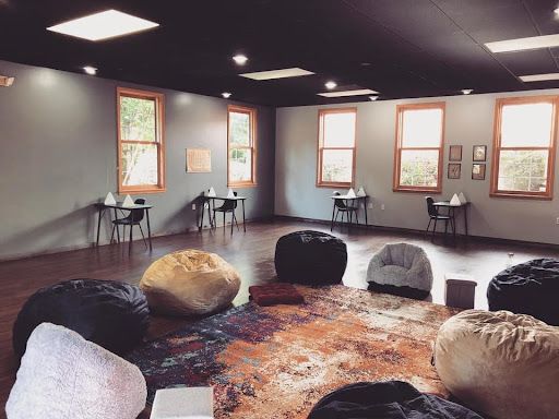 A room filled with bean bag chairs and tables.